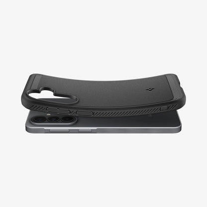 ACS09794 - Spigen Rugged Armor Galaxy A57 5G case in Matte Black lifting away from phone, showing flexible TPU construction