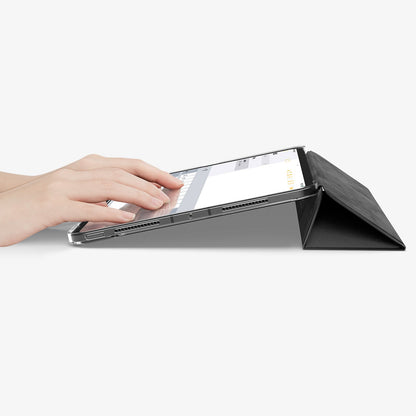 ACS09440 - iPad Pro 11-inch (2024) Case Liquid Air Folio in Black showing a person typing on the device while cover folded into a kickstand