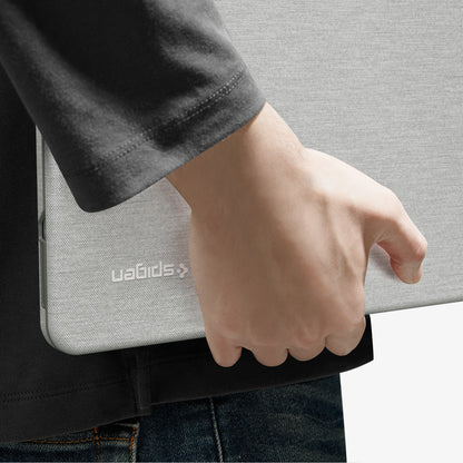 ACS11542 - MacBook Neo 13-inch Urban Fit in Heather Gray showing close up of case tucked under arm, logo detail visible
