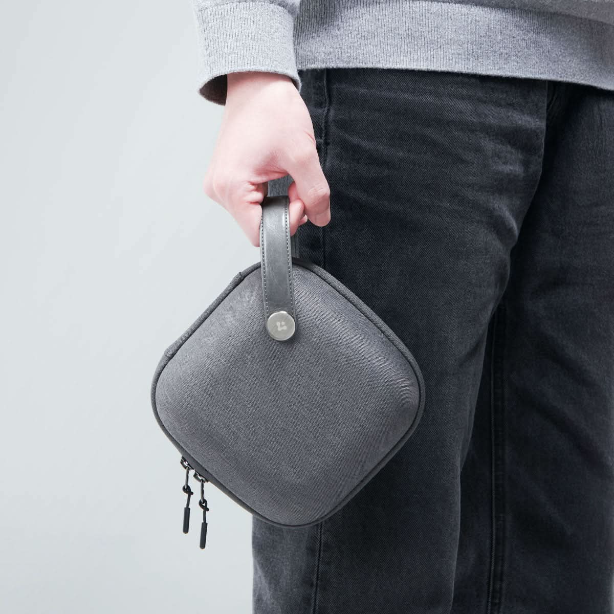 AFA09214 - Mac Mini M4 Klasden Pouch in Charcoal Gray showing the pouch held by it's strap