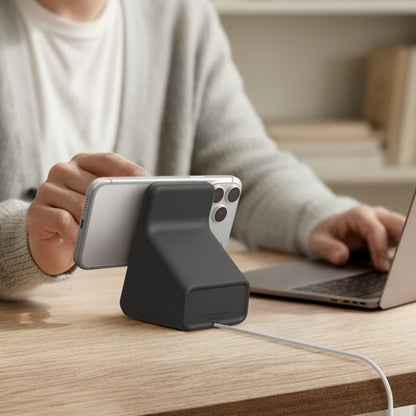 AMP09170 - Magsafe Charger Stand (Mag Fit) in Black showing a person using their device while attached to the magsafe charger stand