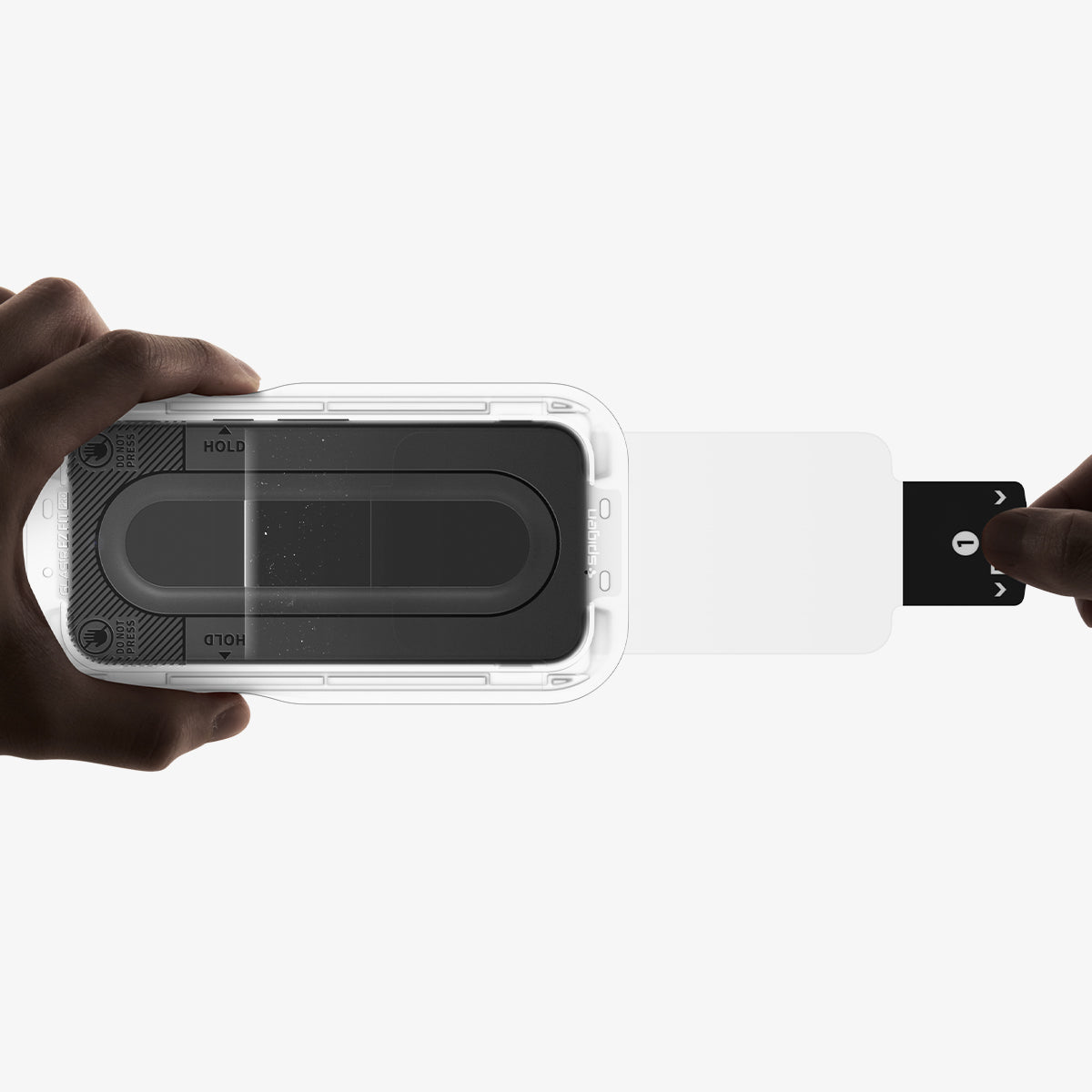AGL11481 - Pixel 11 Pro GLAS.tR EZ Fit | Privacy pull tab removing dust during screen protector installation.
