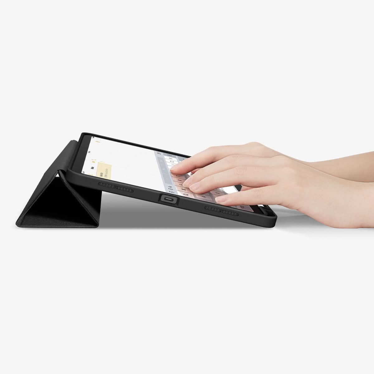 ACS07754 - iPad Air 10.9-inch (2022) Case Urban Fit in Black showing a person's hand typing on the device screen while front case propped up as a built-in kickstand