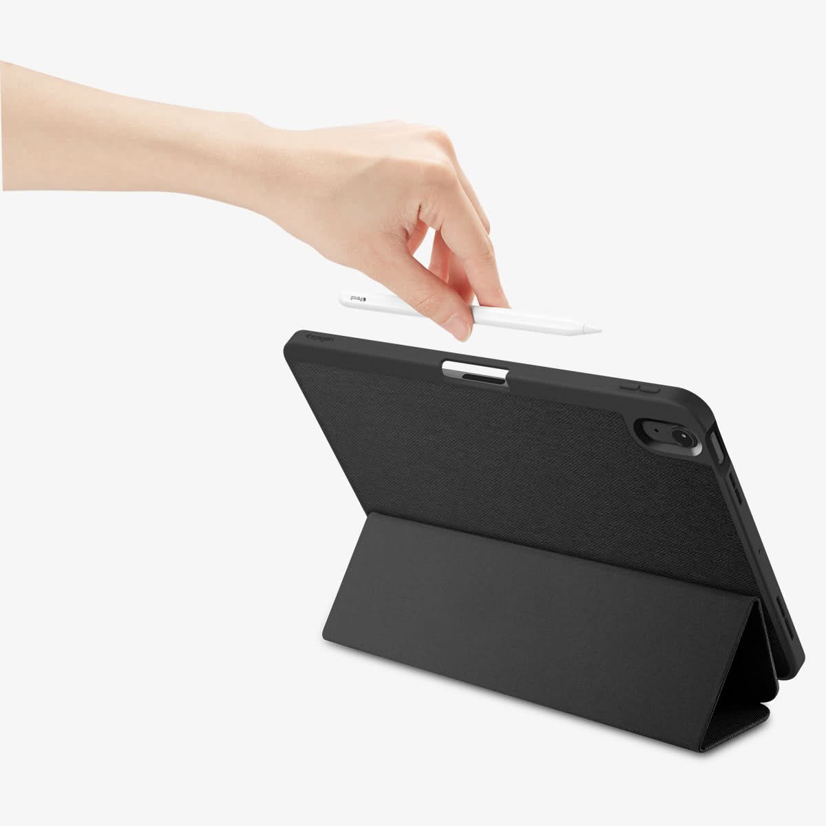 ACS07754 - iPad Air 10.9-inch (2022) Case Urban Fit in Black showing a hand holding the stylus pen ready to attached on the device showing back, propped up as a kickstand