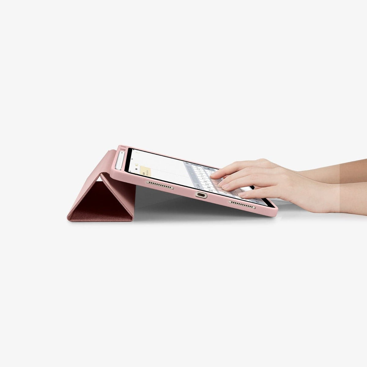 ACS01944 - iPad Air 10.9" Case Urban Fit in rose gold showing hands typing on screen with device propped up by built in kickstand