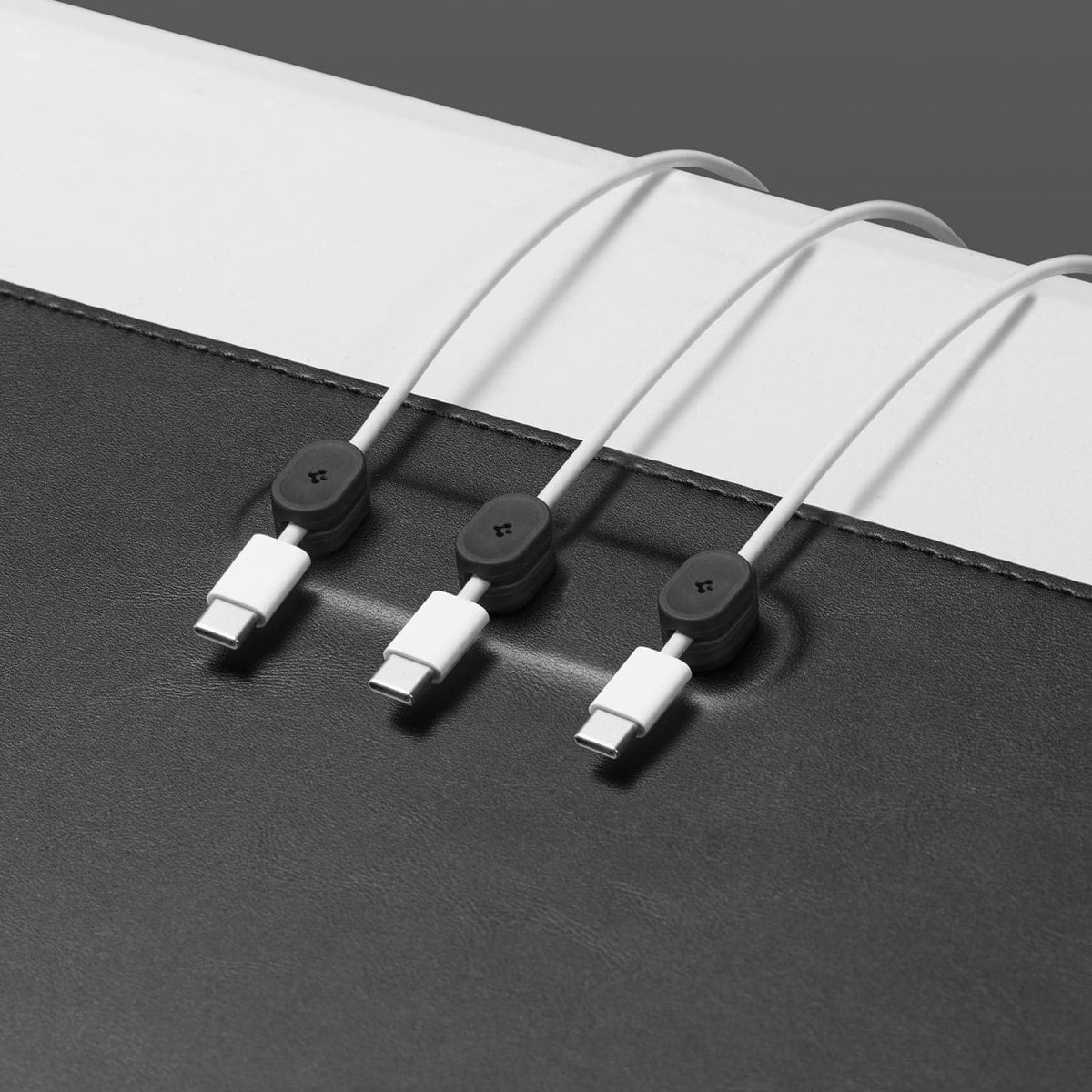 APP05267 - LD302M Magnetic Desk Pad in black showing the cable organizer zoomed in with cables inserted