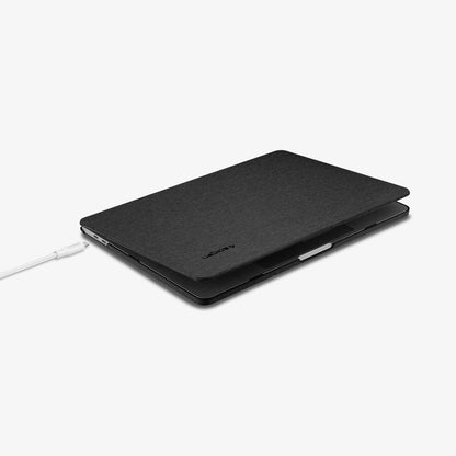 070CS25965 - MacBook Pro 13-inch Case Thin Fit in Black showing the top and side with laptop slightly open and charging cable next to slot