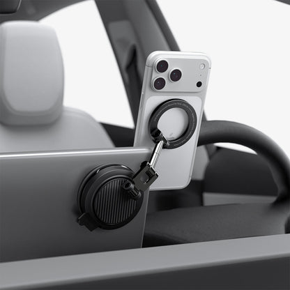 ACP11657 - Spigen MagSafe car mount holding iPhone on Tesla screen edge with suction cup base