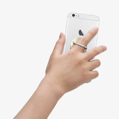 000EP20244 - Style Ring in champagne gold showing the phone in someone's hand with ring attached to back of device
