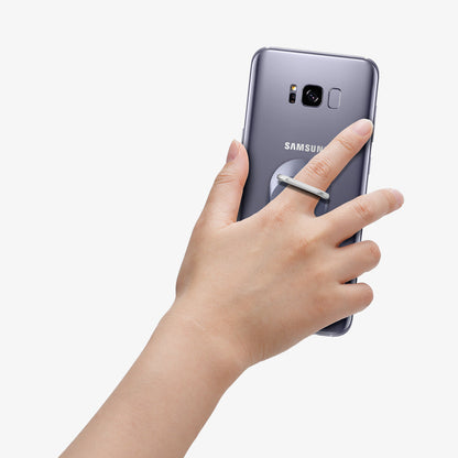 000SR21951 - Style Ring in orchid gray showing the phone in someone's hand with ring attached to back of device