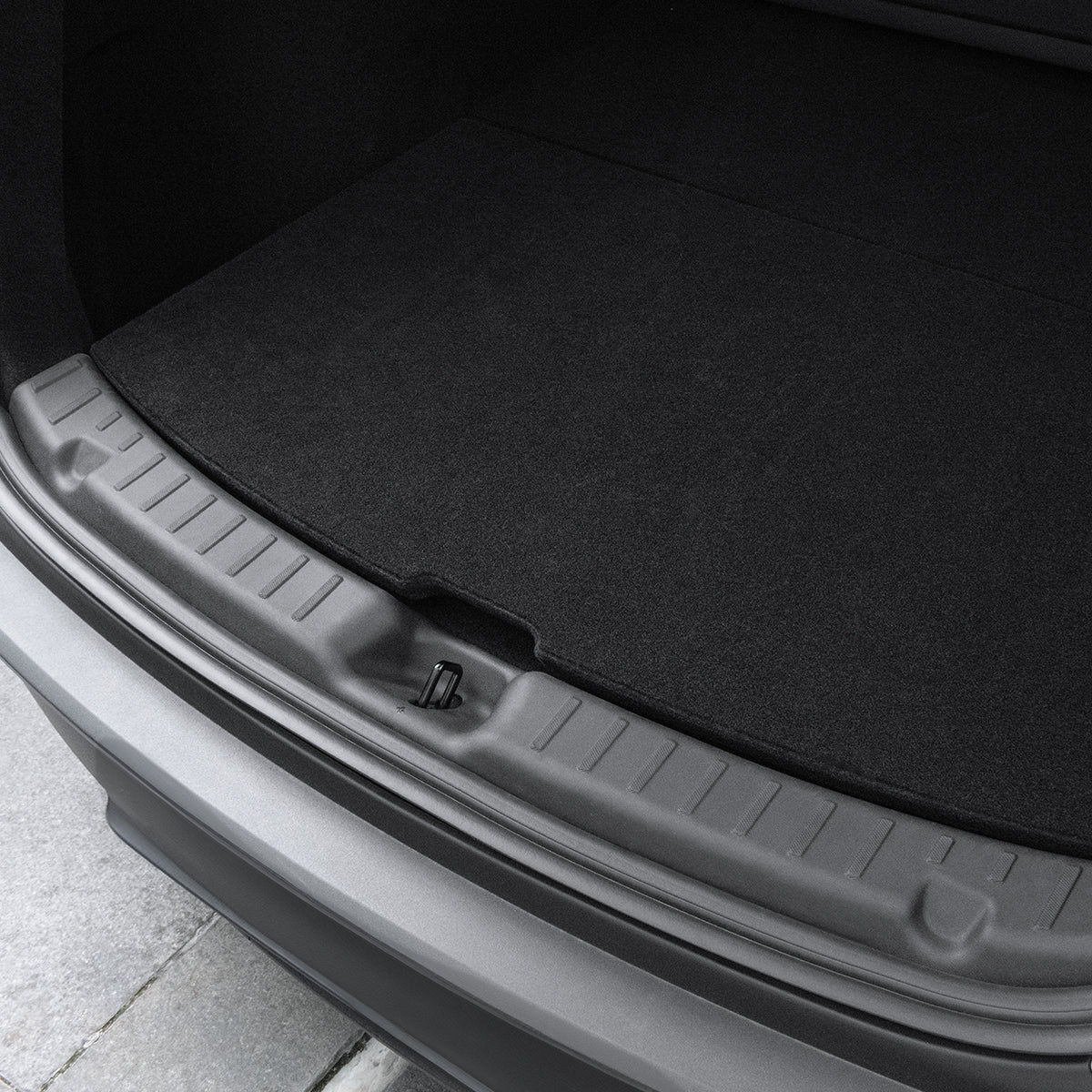 ACP09759 - Tesla Model Y Juniper Trunk Sill Guard | TG100-YJ in black showing the top and bottom view installed inside of a trunk