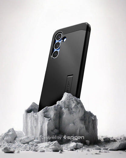 ACS08987 - Galaxy S25 Plus Case Tough Armor AI (MagFit) in Black showing the back, partial side device sitting on the top of a rock